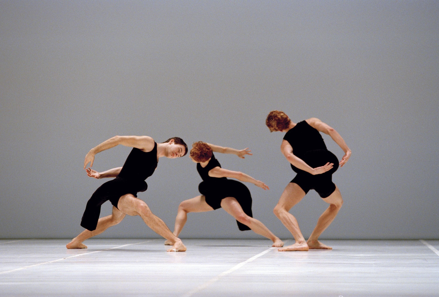 Photograph from Scenario (1997) taken by Jacques Moatti at the Opéra National de Paris in January 1998 featuring the costumes of Rei Kawakubo.  Dancers from L-R: Tom Caley, Lisa Boudreau, and Glen Rumsey.