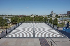 Arcs from four corners, with alternating bands of white and brown stone. The floor is bordered and divided horizontally and vertically by a black stone band