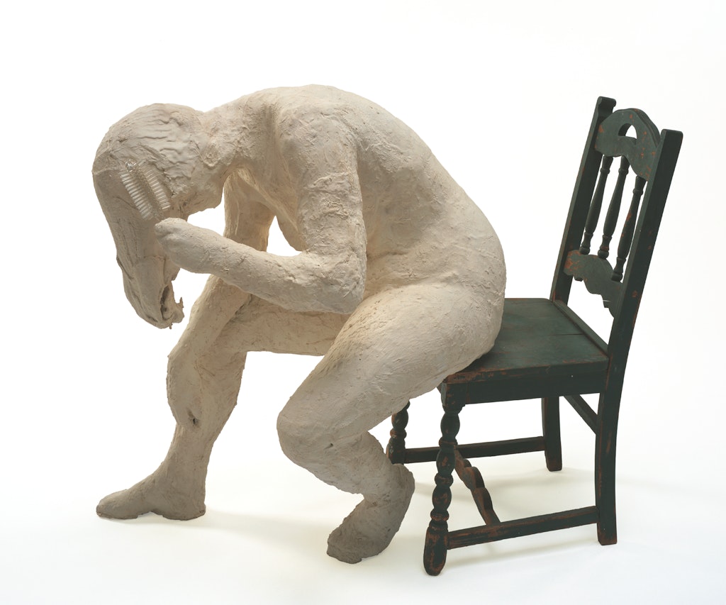 Woman Brushing Her Hair on Green Chair