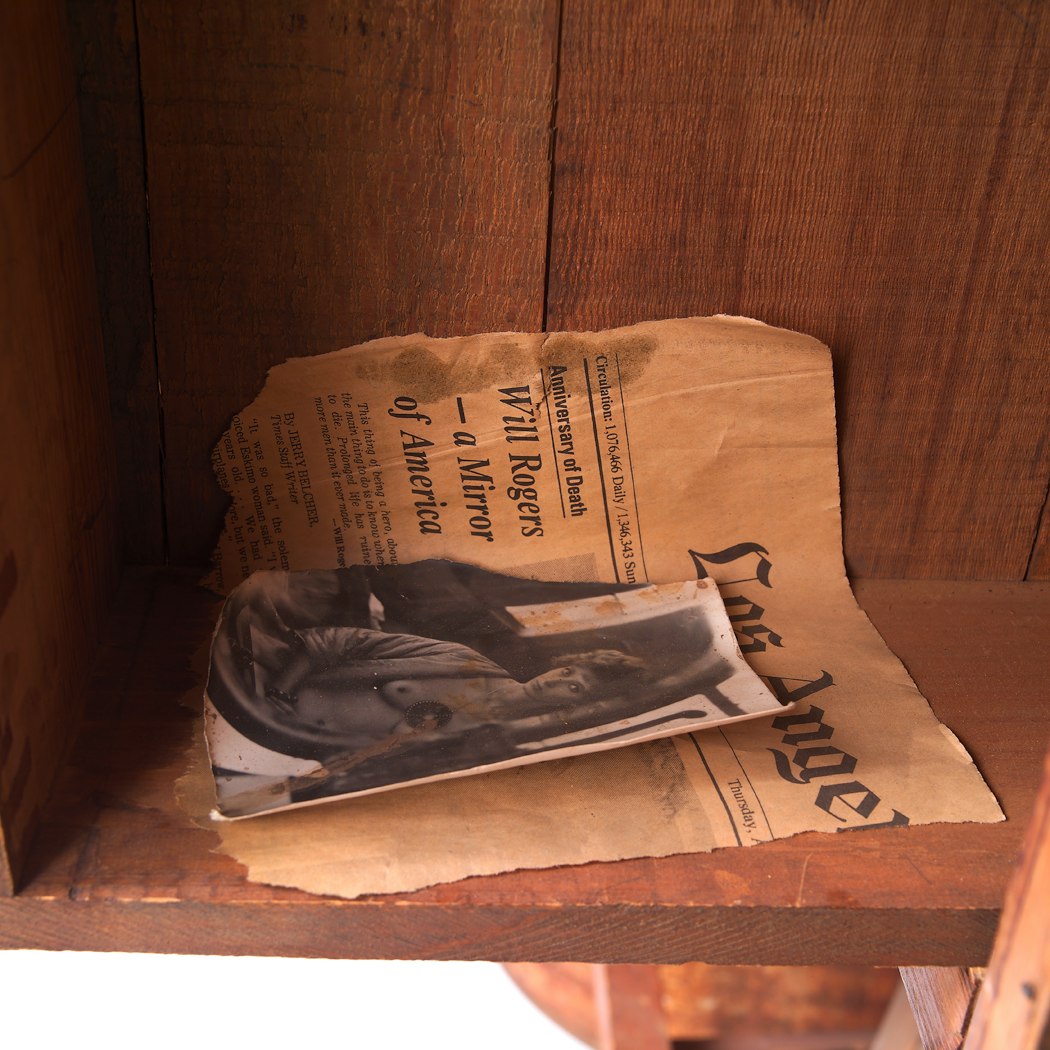 Torn LA newspaper; torn photo of partially nude woman