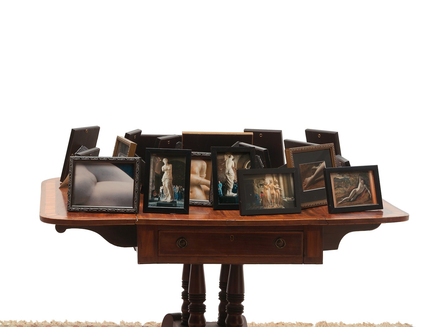 View shows part of table with framed photographs
