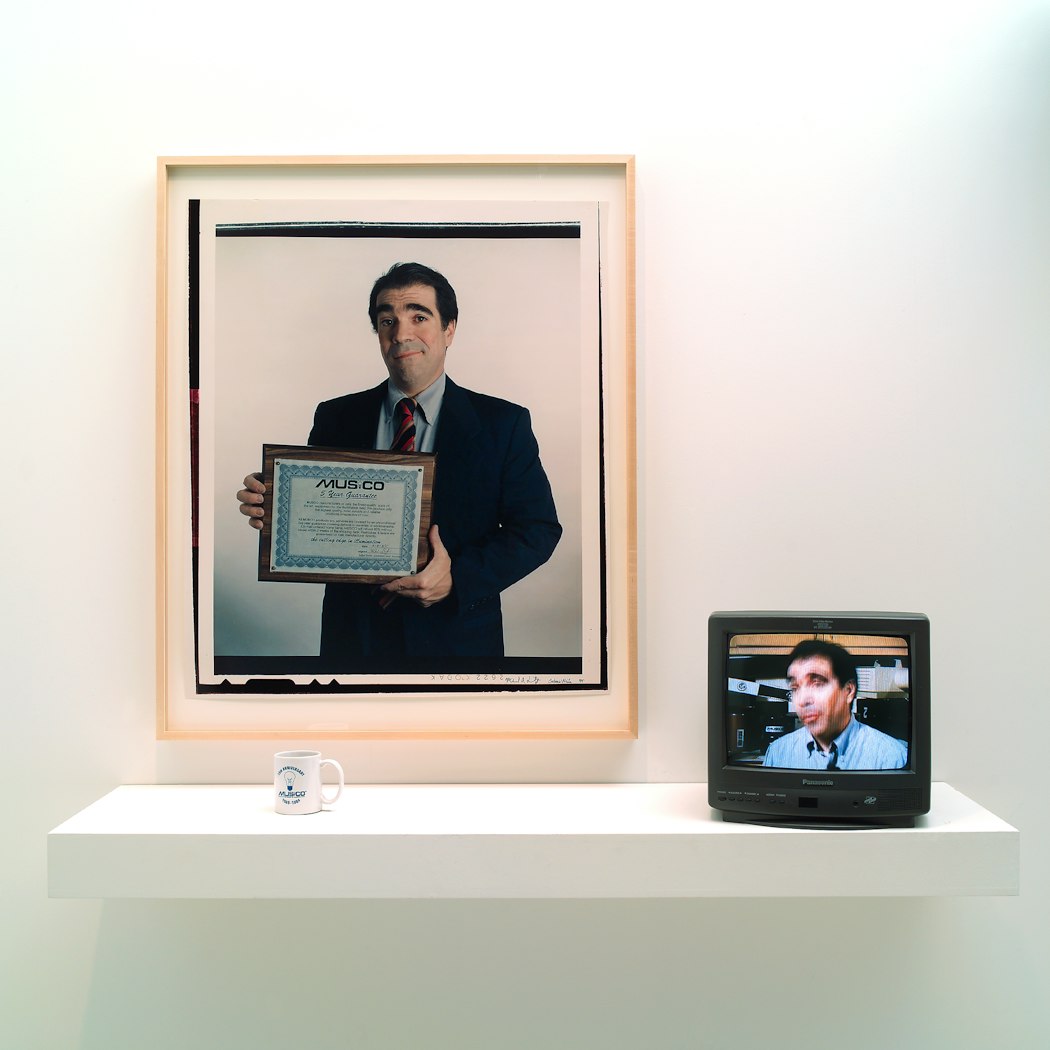 video still shows blurred head & shoulder view of man w/o jacket