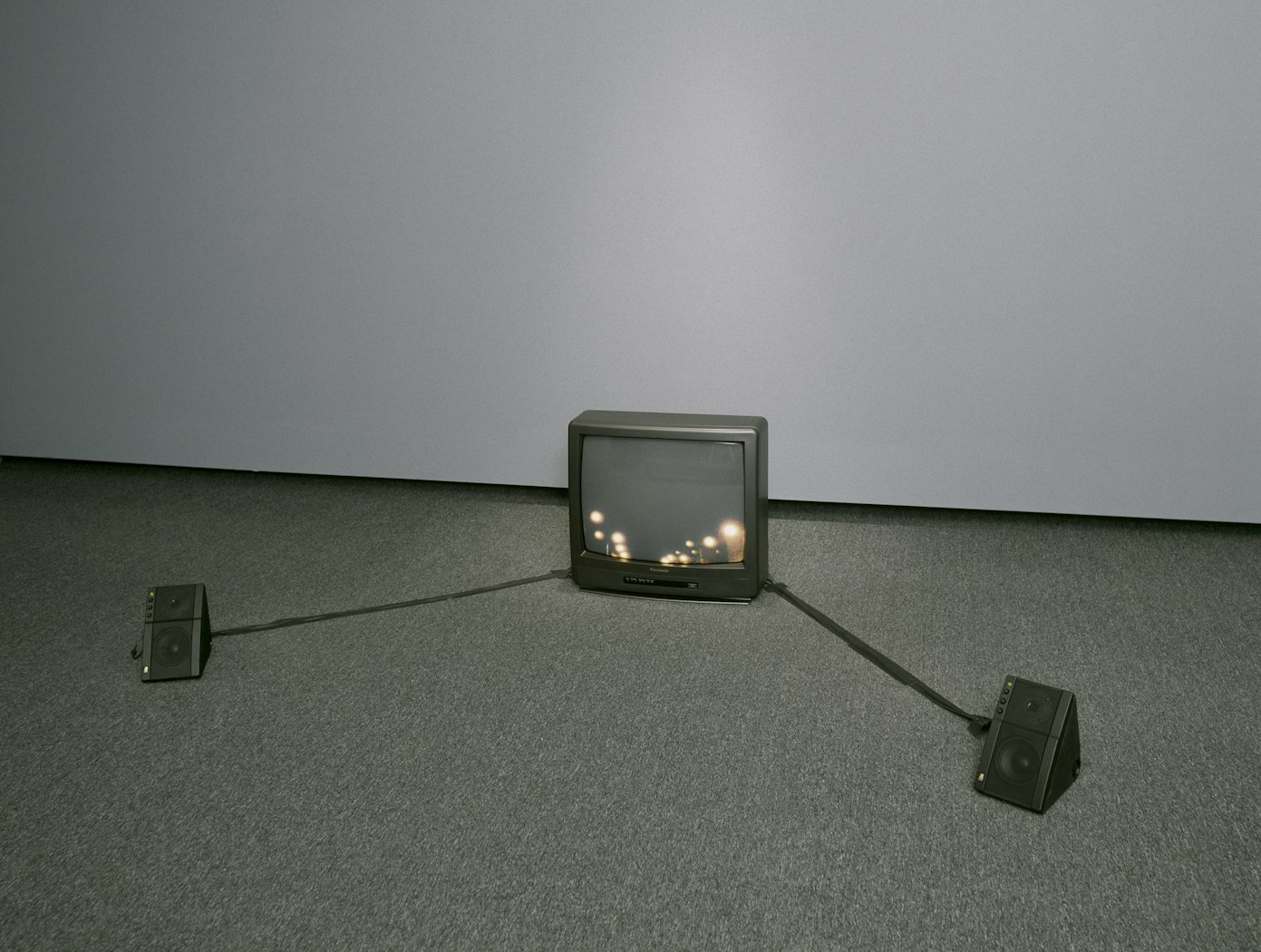 Single monitor on floor with speakers at sides